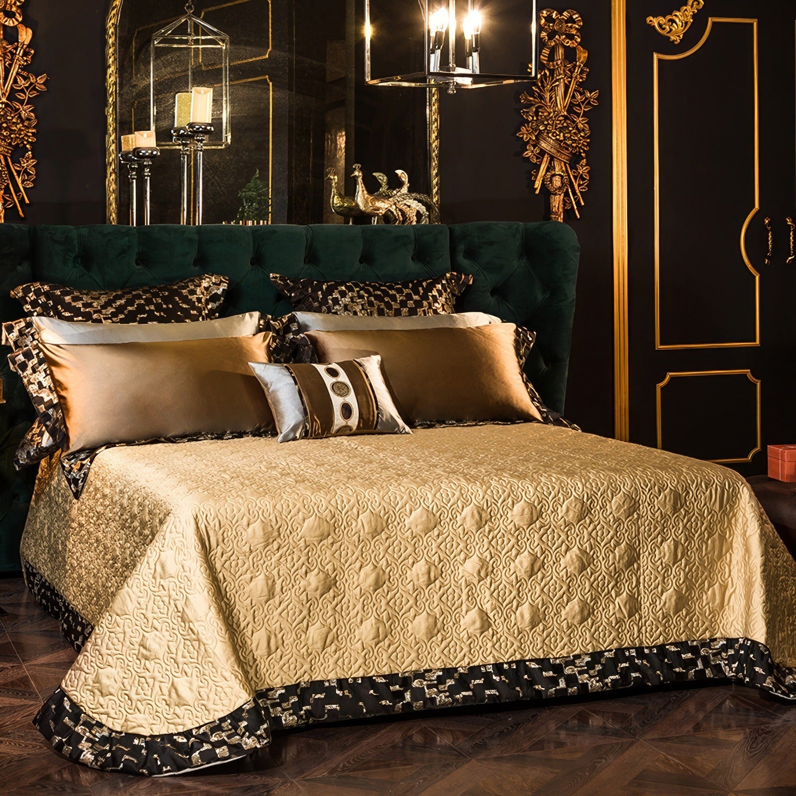 Gold Egyptian cotton quilt with intricate embossed patterns, complemented by black geometric borders. Matching gold and black pillowcases and a decorative cushion with embroidered medallion details rest against a dark green velvet headboard, set in a luxurious bedroom with gold accents and warm lighting.