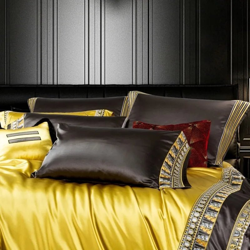 A close-up view of a luxurious bedding set showcasing contrasting pillowcases in deep brown and bright yellow. The brown pillowcases are accented with intricate gold and silver embroidery along the edges, adding a regal touch. A rich red decorative pillow with a textured design enhances the opulent aesthetic. The yellow bedding exhibits a sleek, glossy finish, emphasizing its high-quality material. This elegant composition is perfect for creating a sophisticated and lavish bedroom ambiance.