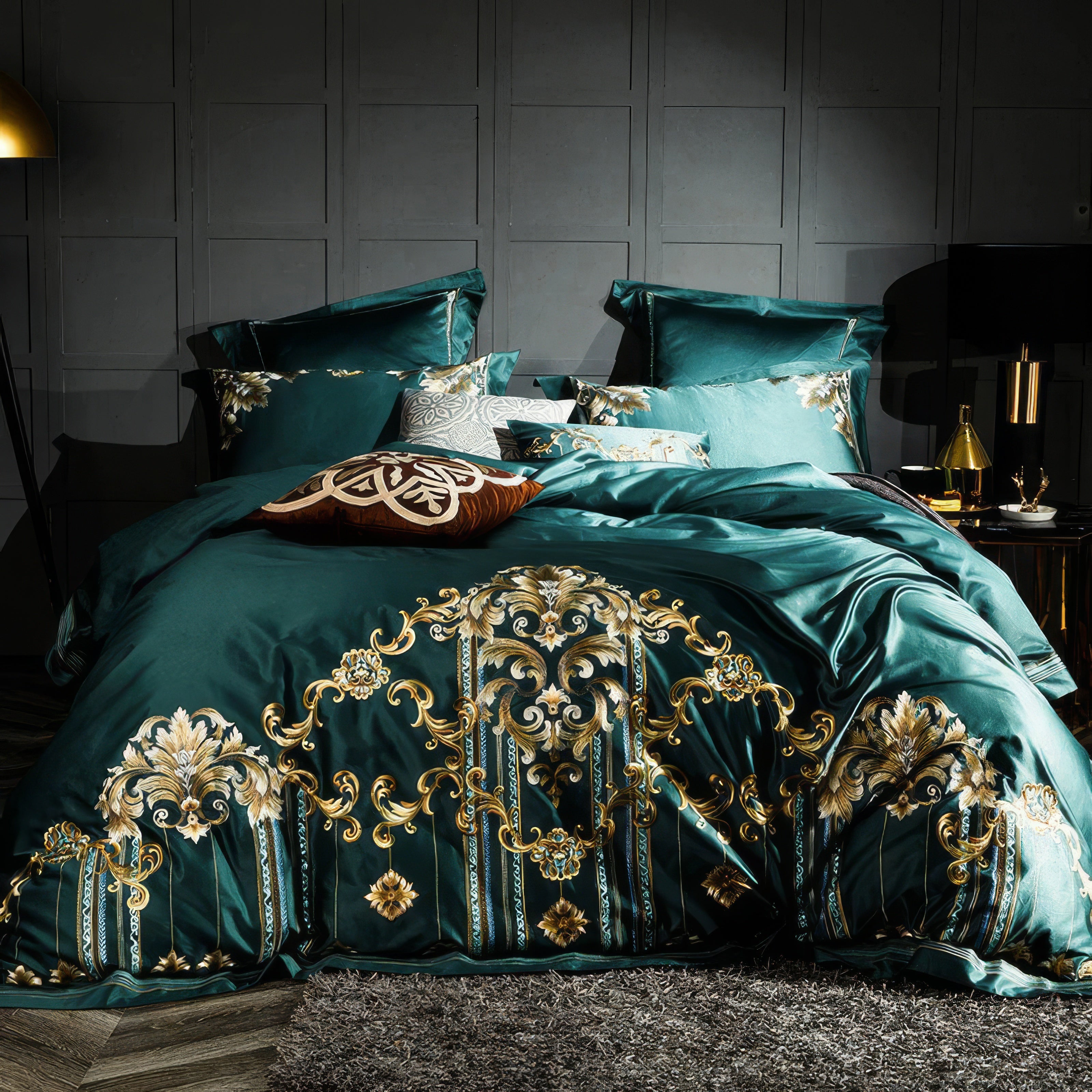 The bedding set features a striking emerald green base adorned with intricate gold embroidery, showcasing ornate baroque-inspired motifs. The plush texture of the duvet and matching pillowcases highlights its luxurious appeal, while the dark gray panel wall in the background enhances the regal ambiance of the setting.

