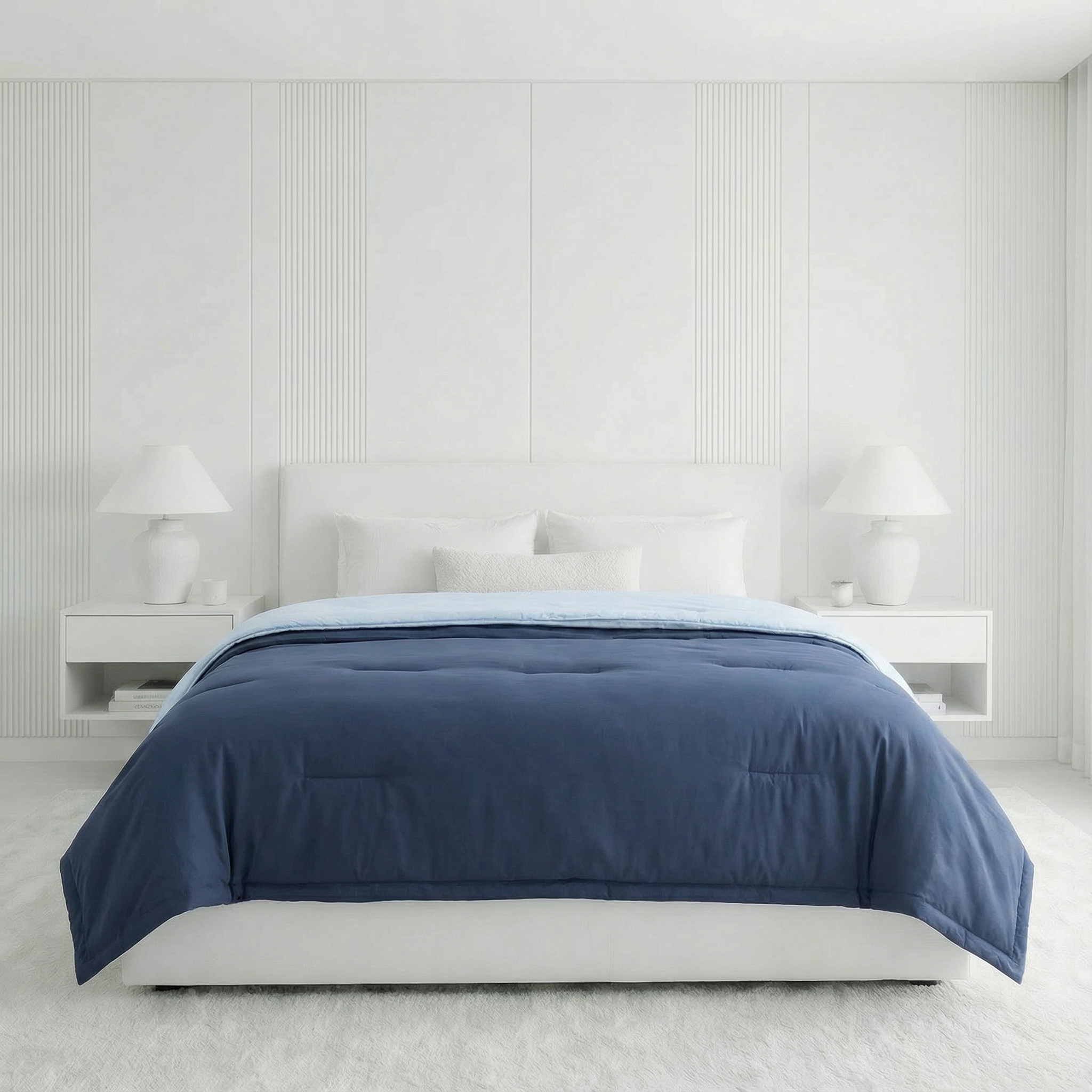 Bed with blue comforter in a minimalistic bedroom