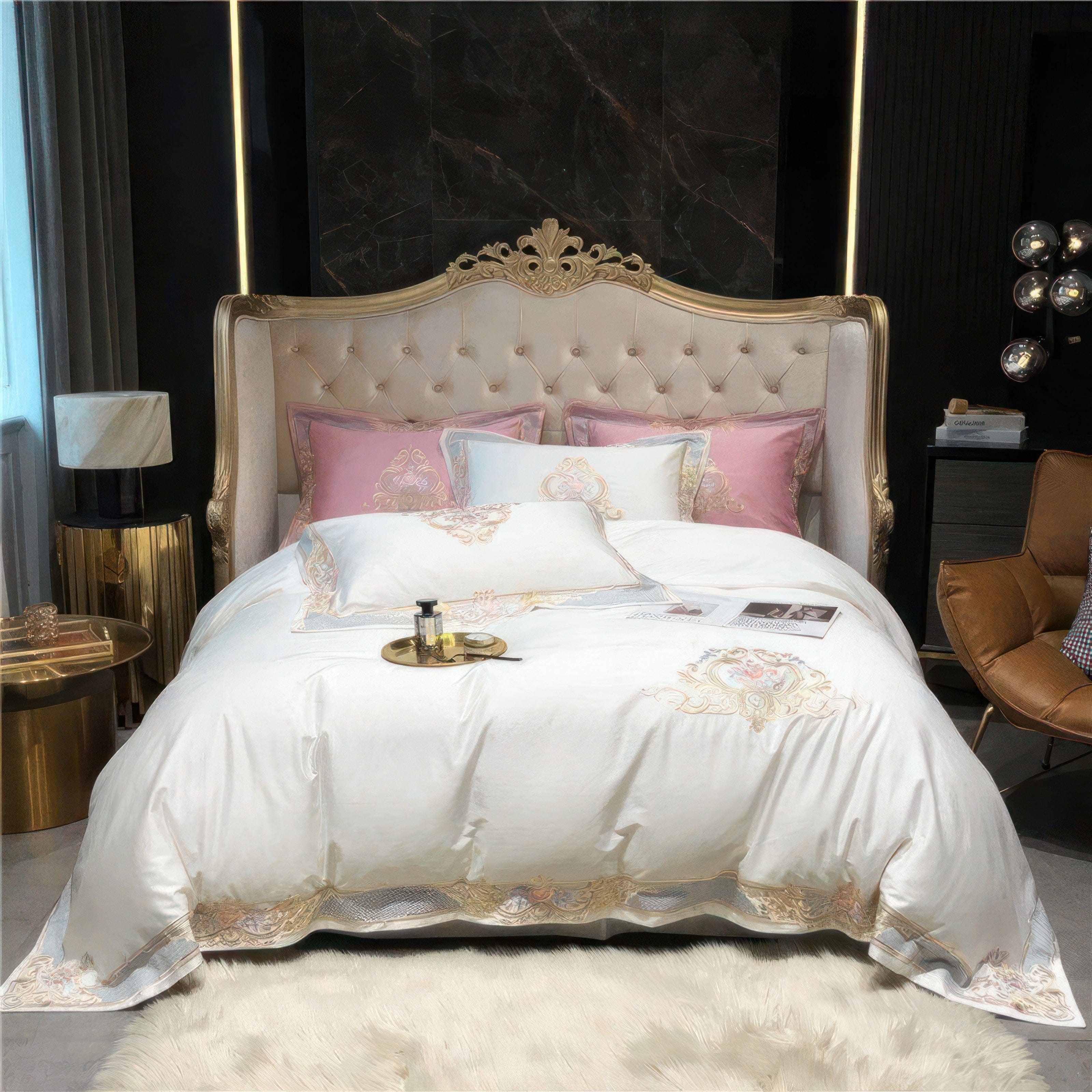 A plush bedding set adorned with soft white fabric featuring ornate gold embroidery and delicate pastel pink accent pillows. The regal headboard, with tufted cream upholstery and gilded framing, complements the luxurious bedding. The setup is accentuated with gold-toned side tables and modern decor, offering a blend of classic elegance and contemporary sophistication.

