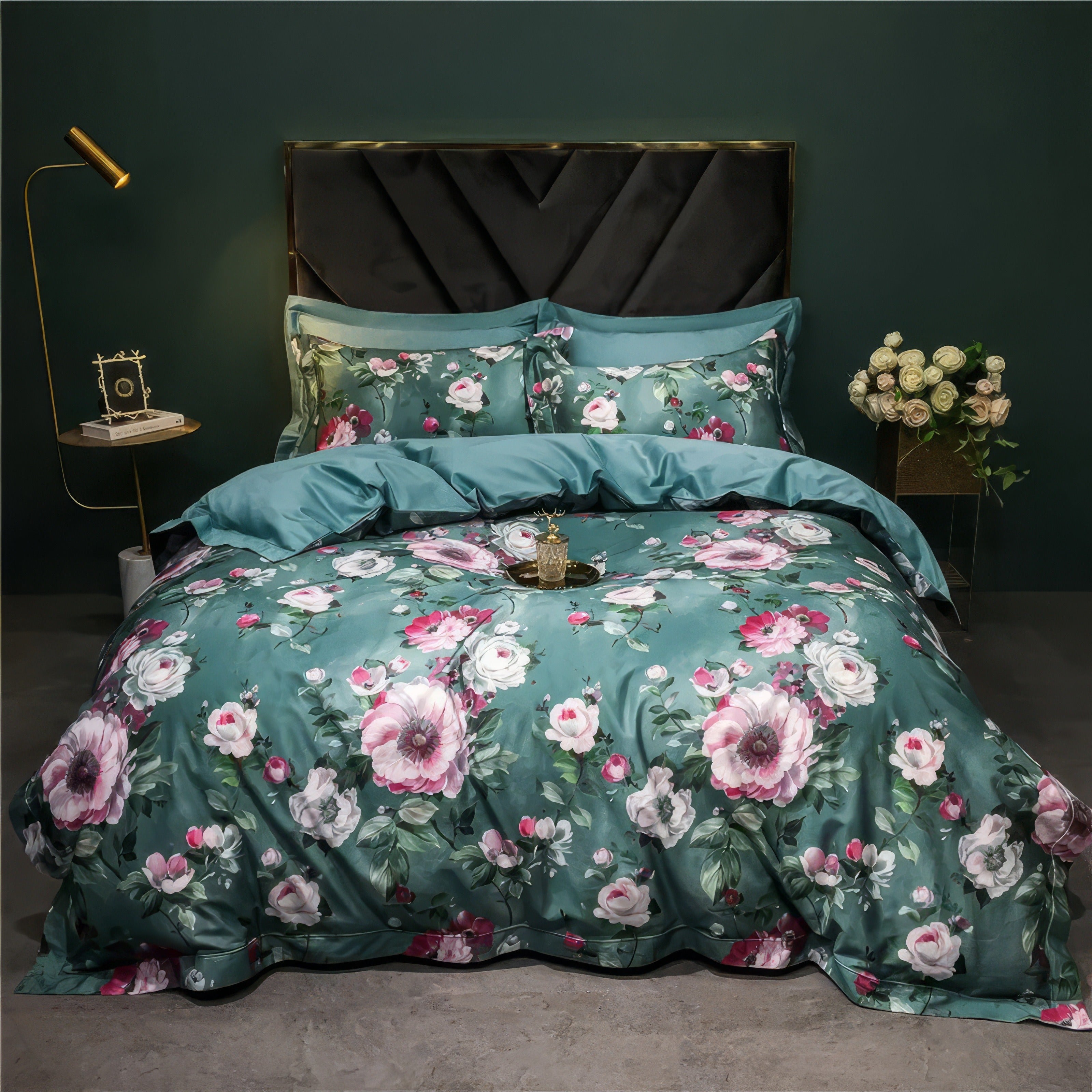 Luxurious Egyptian cotton bedding set in a rich teal shade adorned with blooming floral patterns in soft pink and white hues. The ensemble includes a matching duvet cover, pillowcases, and solid teal sheets, perfectly styled in a modern bedroom with a velvet headboard, golden decor accents, and a bouquet of white roses for a sophisticated touch.

