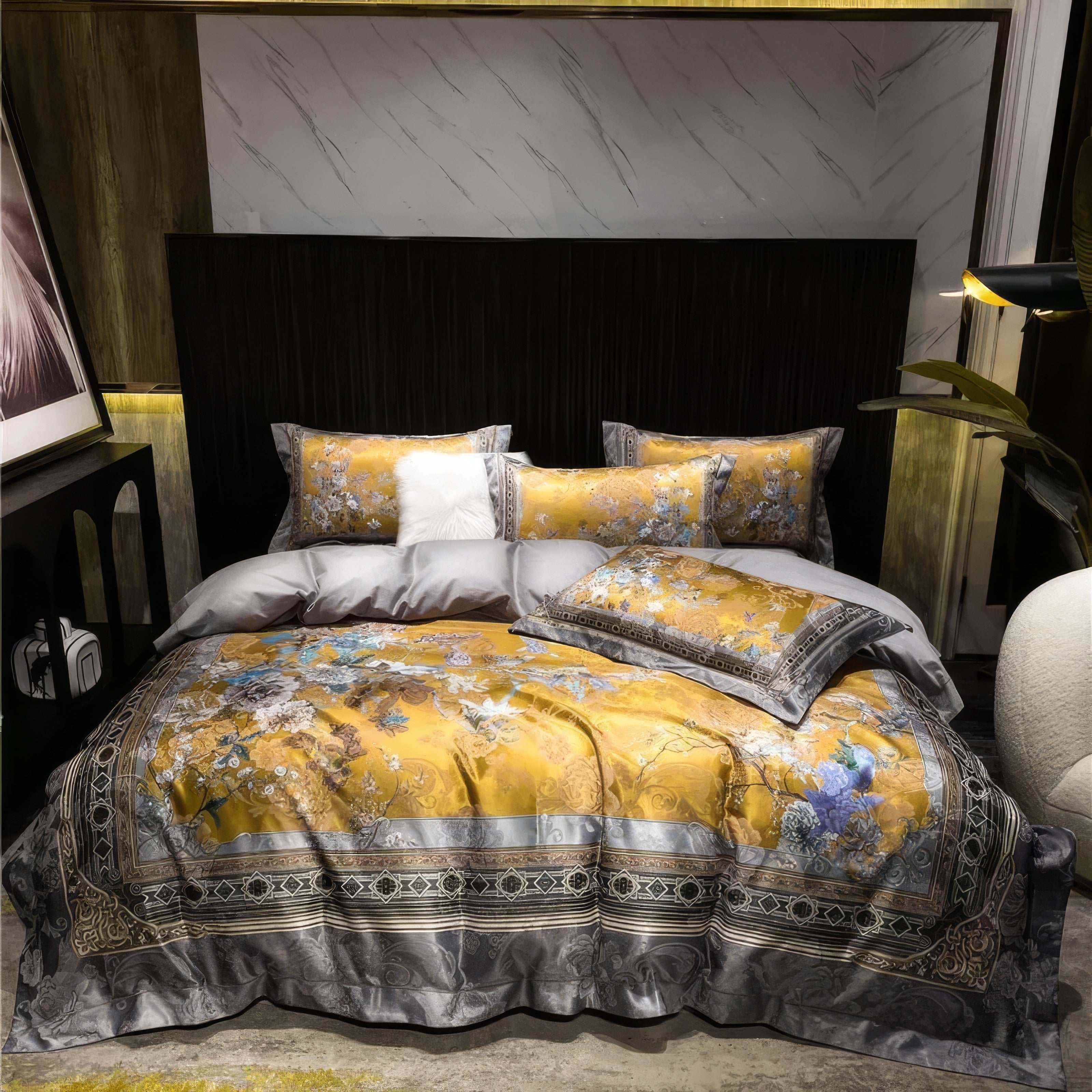 Luxurious bedding set with a golden floral pattern and gray detailing, featuring matching pillowcases, a decorative pillow, and a plush gray duvet on a contemporary bed against a dark, paneled headboard.

