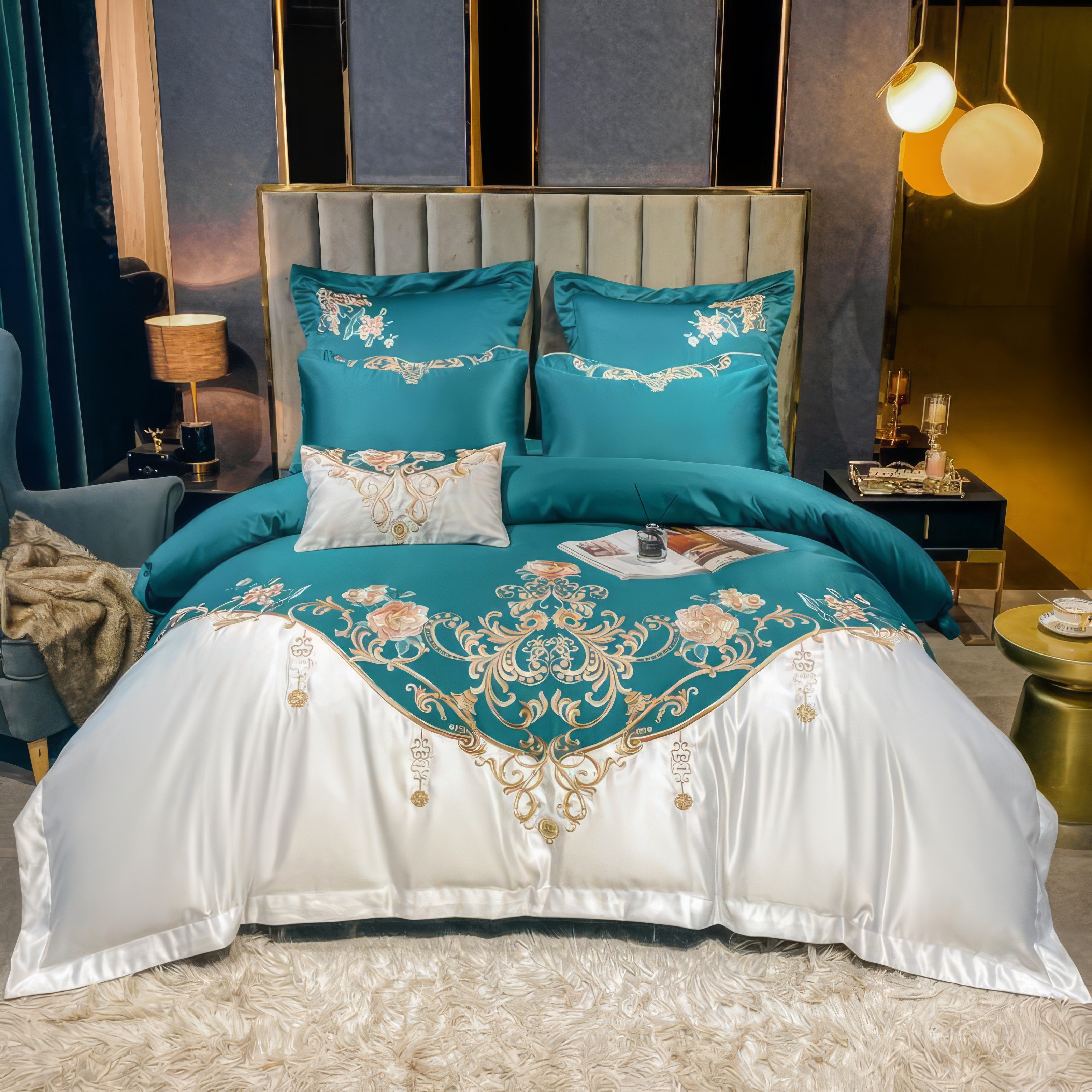 A luxurious bedding set in teal and white, featuring intricate floral embroidery and golden ornamental details. The bed is styled in an elegant room with velvet green curtains, a plush grey armchair, and a softly lit bedside table, complemented by golden decorative accents and a fluffy white rug.

