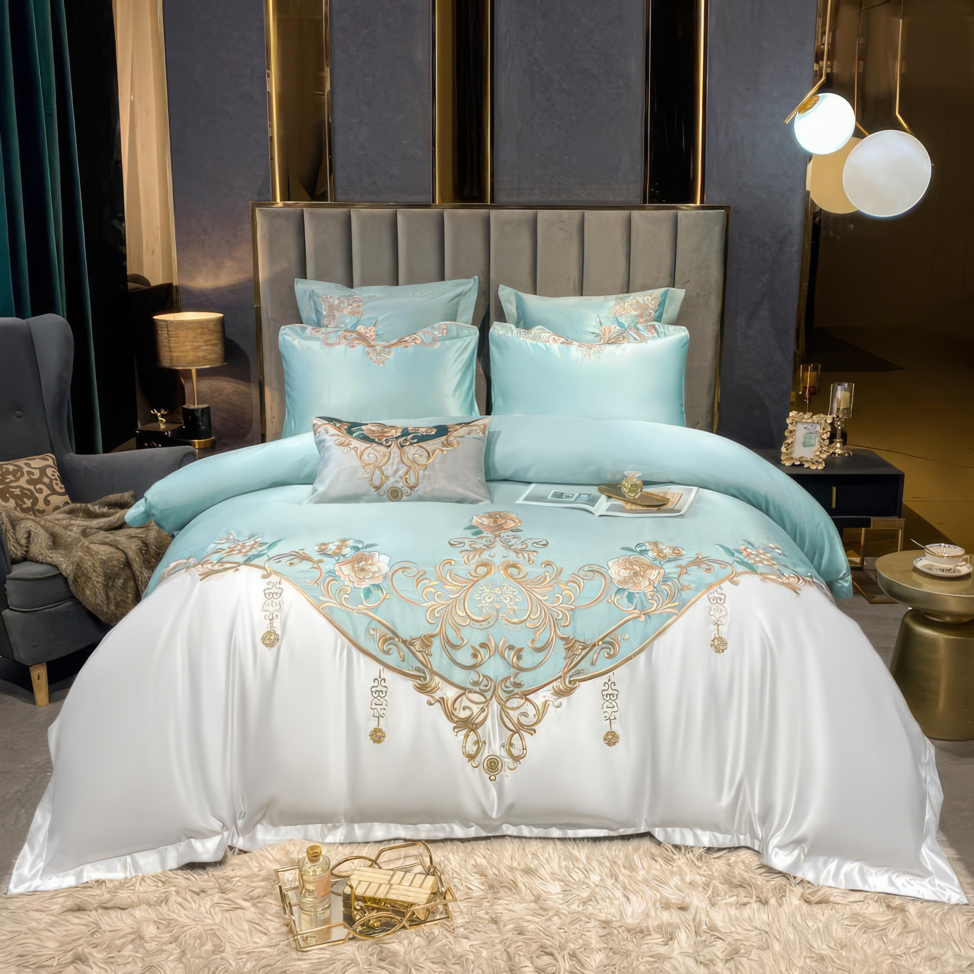 A luxurious bedding set in a serene aqua tone paired with white accents, featuring ornate golden floral embroidery with touches of pastel pink and green. The bed is styled with coordinating decorative pillows and a refined ambiance created by soft lighting, gold accents, and plush textures. The overall aesthetic exudes elegance and sophistication, ideal for an opulent bedroom setting.

