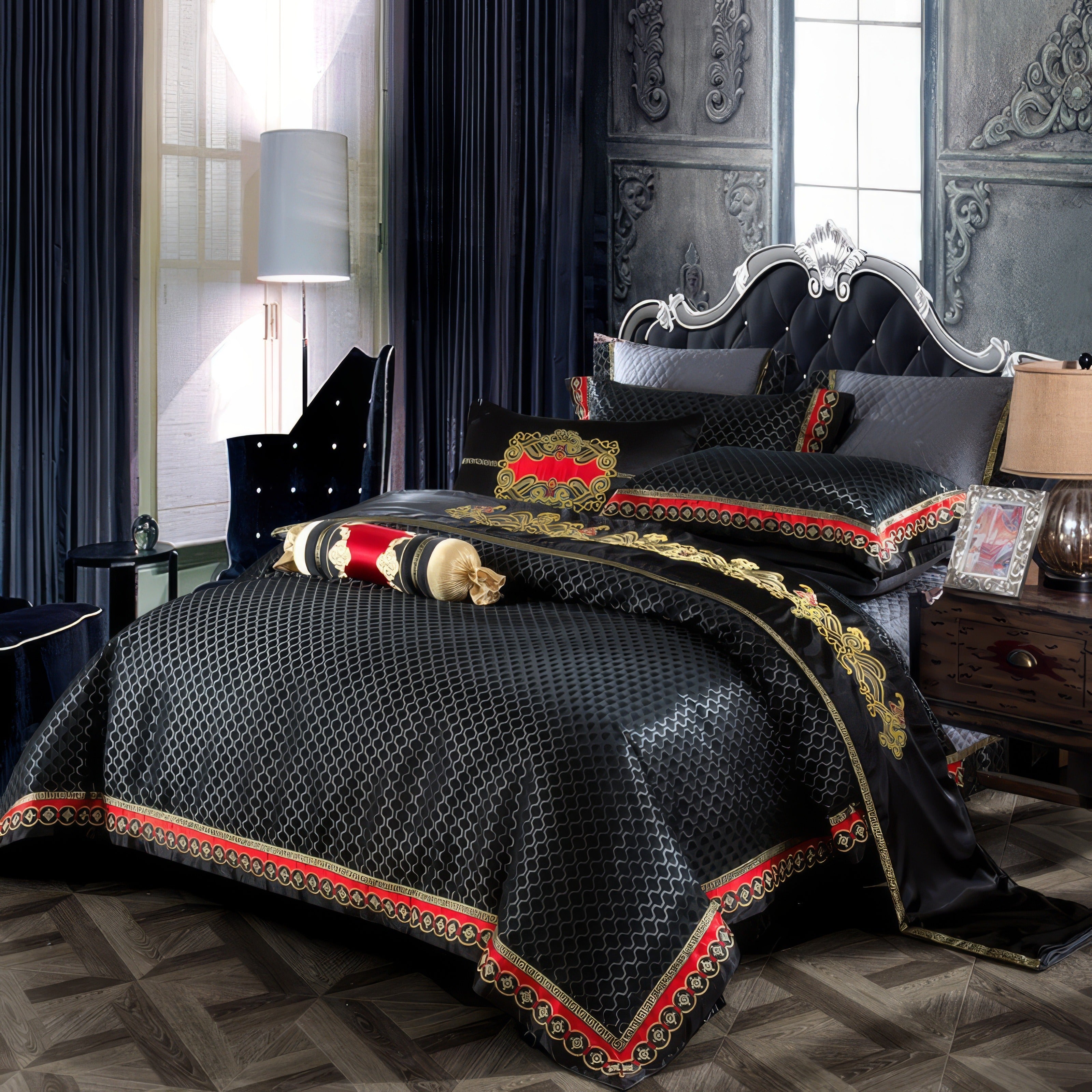 A bold and luxurious black bedding set accented with gold and red embroidery that adds a royal charm to the bedroom. The bedding features intricate patterns, complemented by matching pillows and a bolster with ornate detailing. The black tufted headboard with silver embellishments creates a dramatic backdrop, while the deep blue curtains and classic paneling enhance the opulent atmosphere. This setting combines timeless elegance with a modern flair, making it perfect for a stately and refined bedroom.

