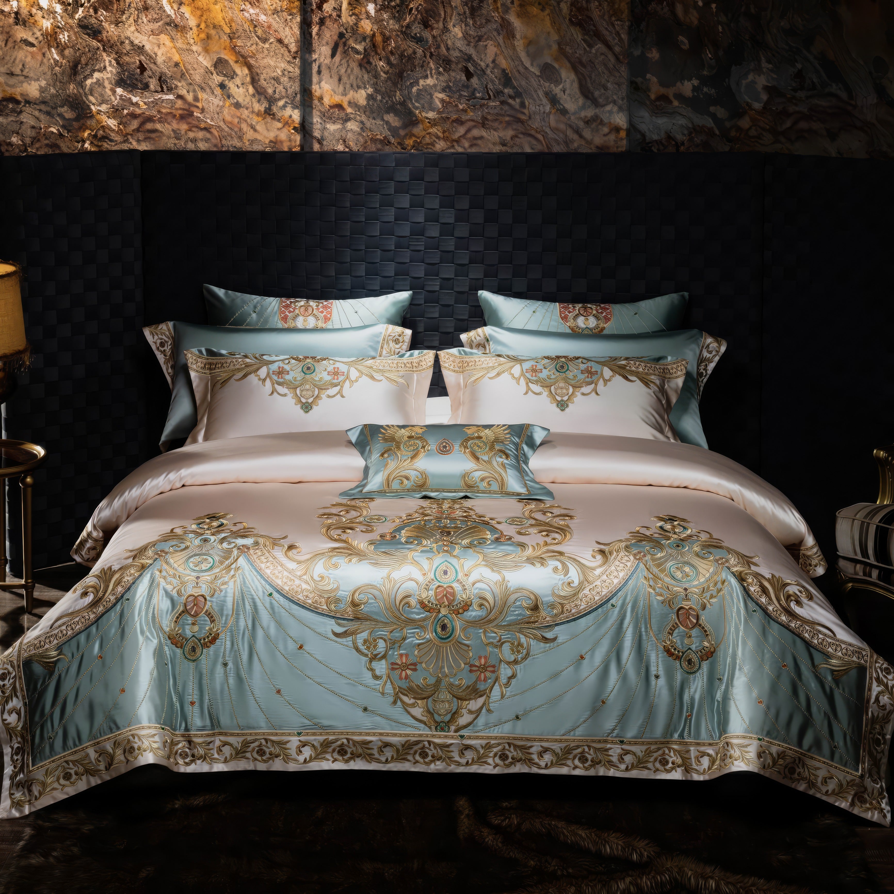 Luxurious bedding set with a light blue and cream color palette, featuring intricate gold embroidery and baroque-inspired patterns, styled with matching pillowcases and a decorative throw pillow in an elegant bedroom with a textured wall backdrop.