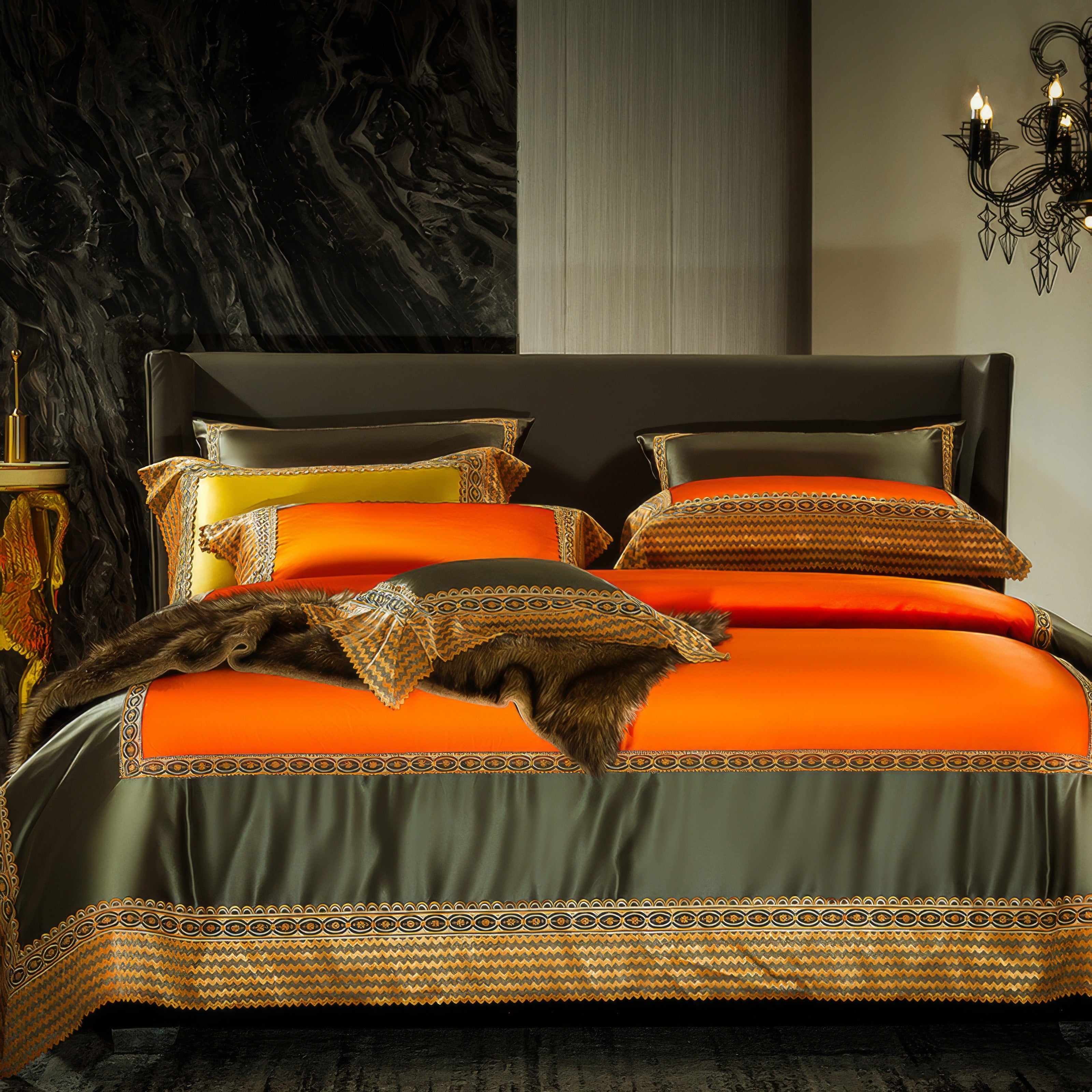 Luxurious bedding set featuring vibrant orange and olive green tones with intricate geometric embroidery, matching pillowcases, and a decorative faux fur accent draped across the bed.

