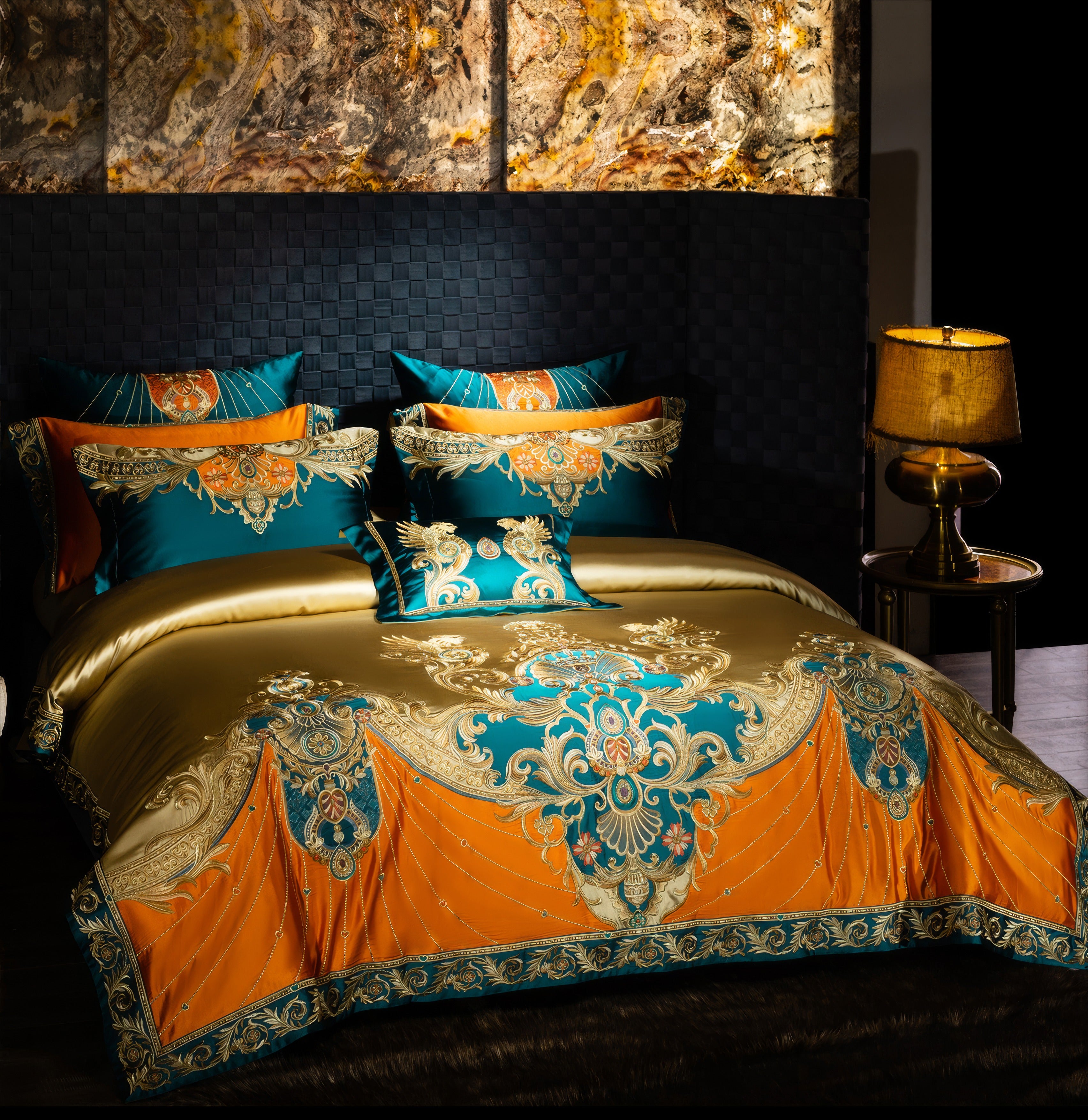 Luxurious bedding set in teal, orange, and gold with intricate baroque-style embroidery, featuring matching pillowcases and a decorative throw pillow, styled in a sophisticated bedroom with a golden lamp and marble-accented backdrop.