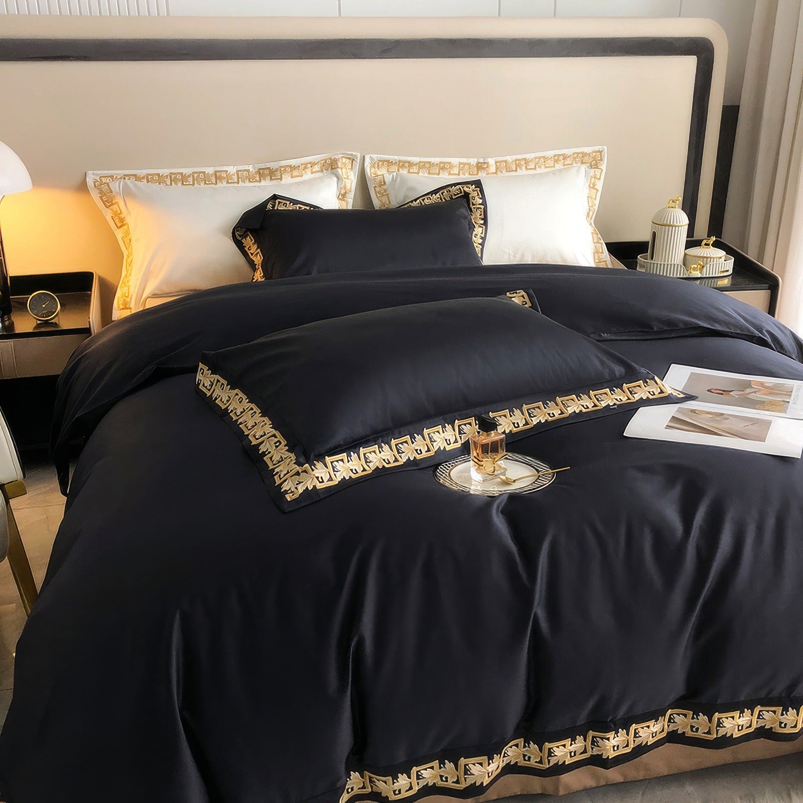 Luxurious black bedding set crafted from premium Egyptian cotton, featuring intricate gold embroidery along the edges, complemented by white pillows with matching gold trim for an elegant and sophisticated touch.

