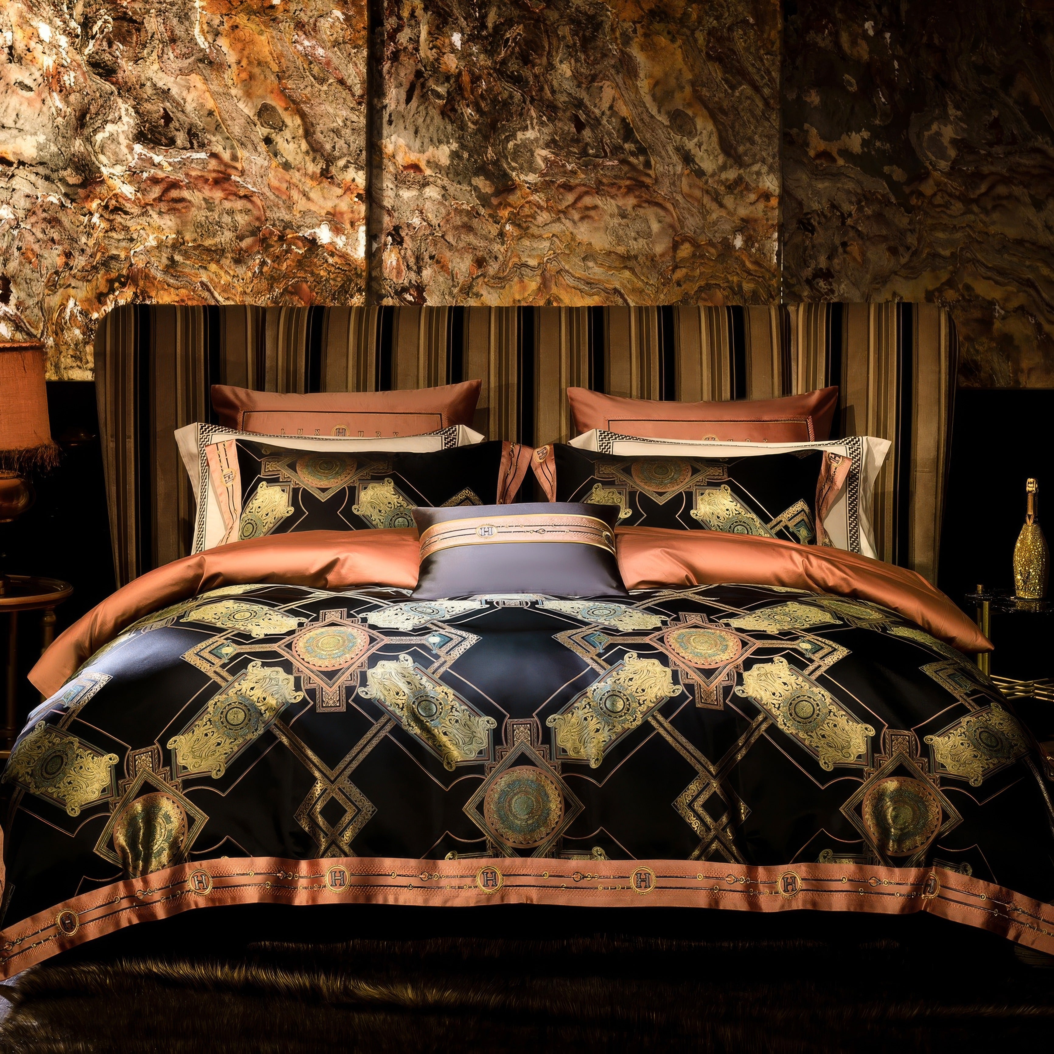 A luxurious bedroom setup featuring an opulent bed dressed in an intricate black and gold bedding ensemble with geometric patterns and regal medallion designs. The bedding is complemented by warm copper-toned pillowcases and decorative cushions, creating a harmonious blend of sophistication and elegance. The headboard is upholstered in striped fabric, adding texture and a modern edge to the arrangement. Behind the bed, a dramatic wall with a rich, marbled design adds a striking backdrop, while soft lighting