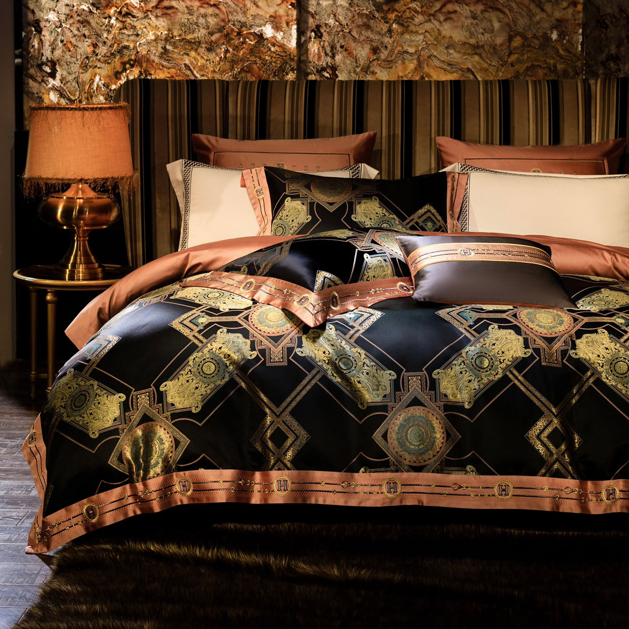 A luxurious bedding ensemble featuring a bold black base with intricate gold and copper geometric patterns, complemented by rose gold accents. The duvet cover and pillows exude opulence with their metallic motifs and fine details. The setting includes a golden table lamp with a fringed shade, a striped upholstered headboard, and a rich fur-like bedspread at the base. The background boasts a textured wall art piece, adding depth and elegance to the room's overall design. This setup creates a refined, warm, a