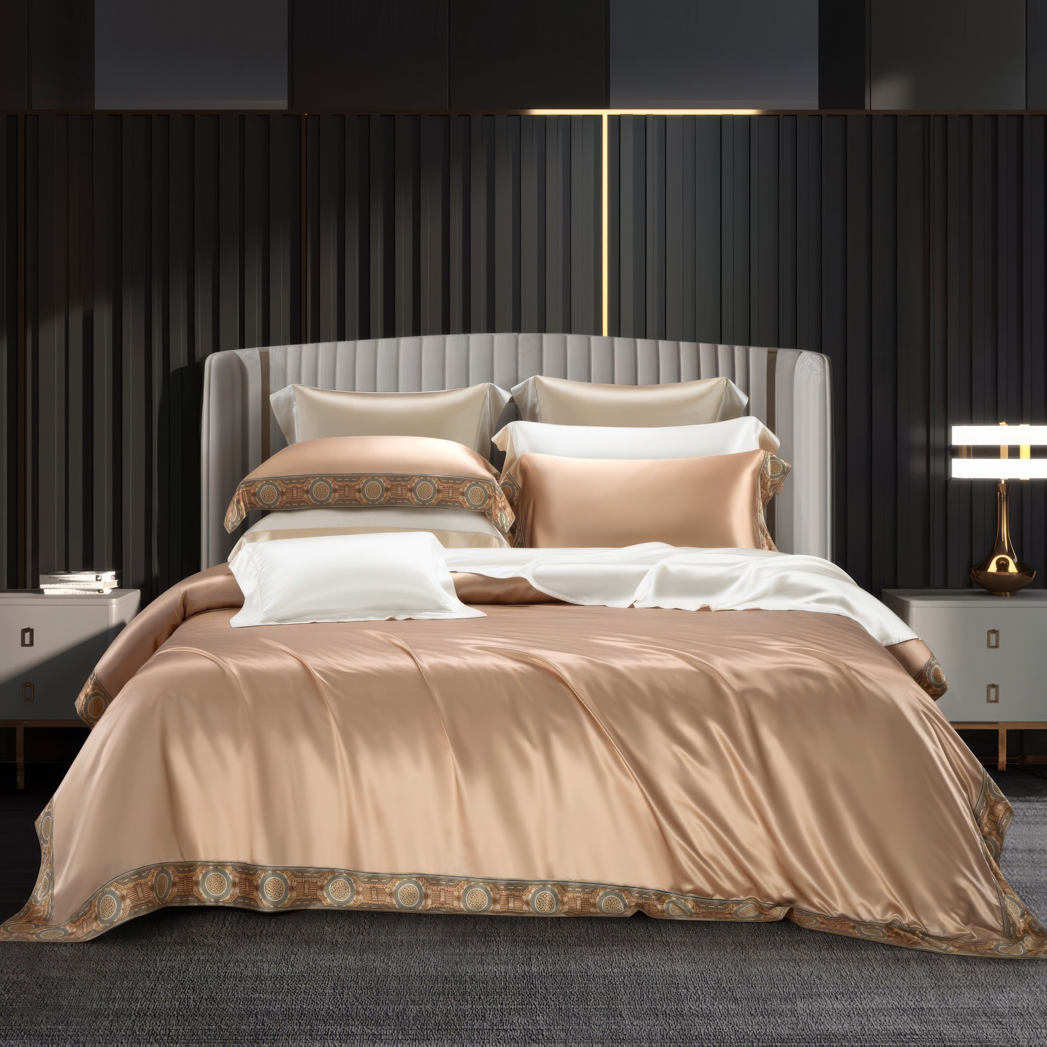 A luxurious bedding set in champagne gold silk, elegantly displayed on a contemporary bed. The duvet and pillowcases are adorned with intricate patterned borders, blending golden tones with detailed motifs. The setting features a dark modern backdrop with gold accents, complemented by matching bedside tables and ambient lighting for a sophisticated atmosphere.