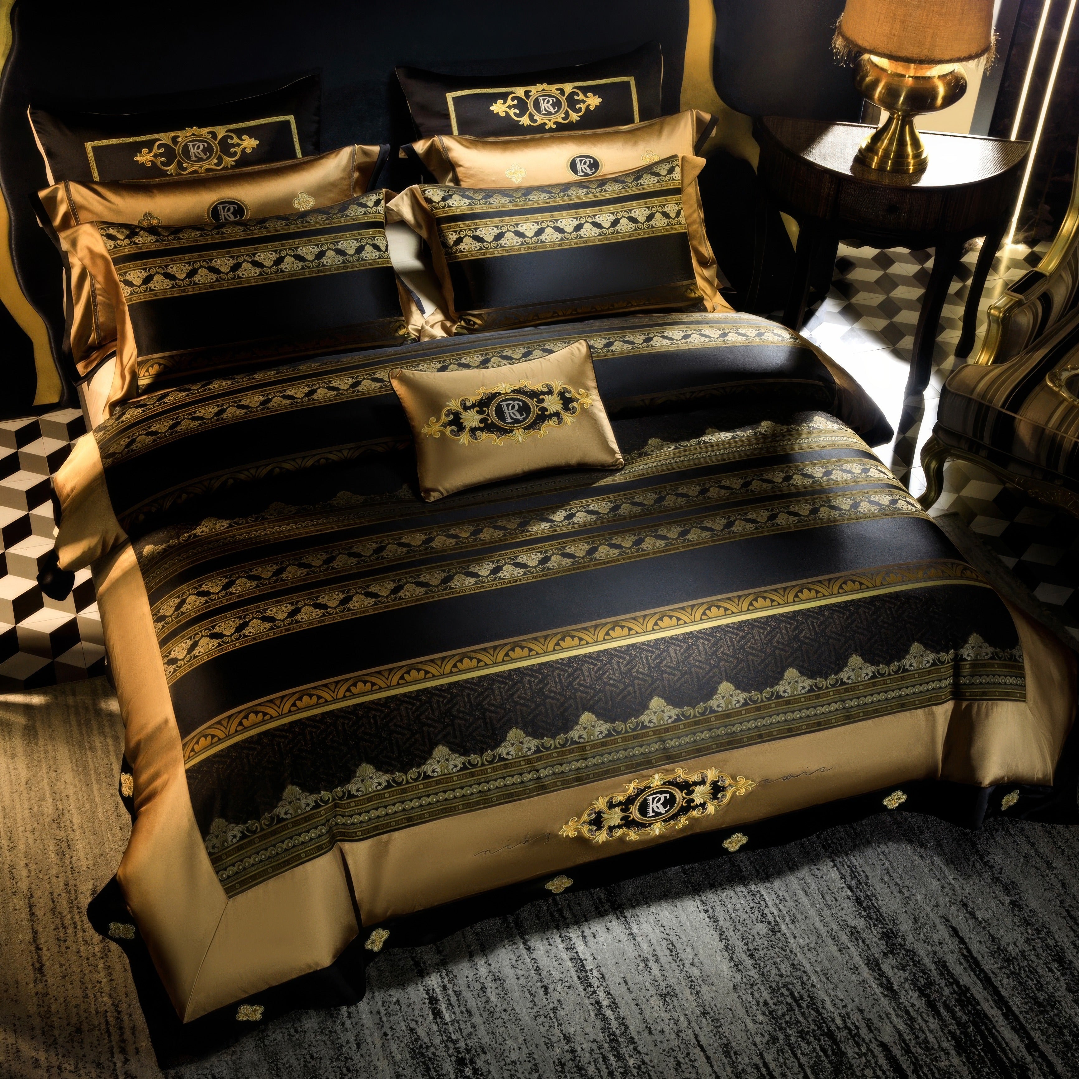 A luxurious bedding set with a striking black and gold design, featuring a duvet cover, pillowcases, and a decorative cushion, all adorned with intricate golden embroidery and baroque-inspired patterns. The centerpiece includes a monogrammed crest. The bed is placed in a regal bedroom with geometric black-and-white tile flooring, a gold-accented side table with a warm-toned lamp, and a striped upholstered chair partially visible. The lighting highlights the opulent textures and rich tones, creating a sophis