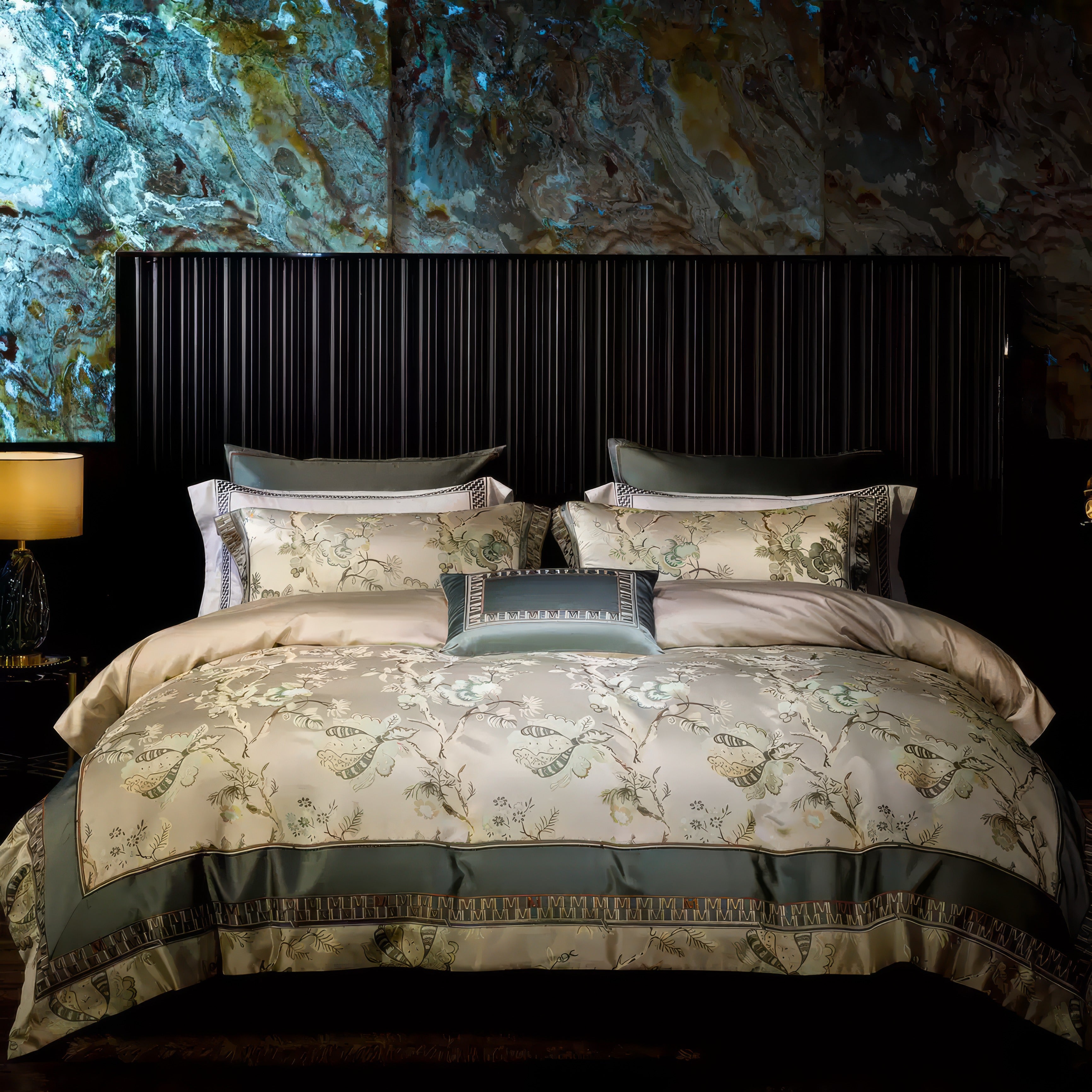 This image showcases a beautifully styled bedroom with a luxurious bed dressed in a soft beige and sage green bedding set. The intricate floral and butterfly patterns on the duvet cover and pillow shams create an elegant, nature-inspired theme. A rectangular accent pillow with a matching color scheme and delicate geometric borders adds refinement. The dark, paneled headboard provides a striking contrast, while the marble-patterned wall with shades of gold and blue adds depth and texture to the backdrop.