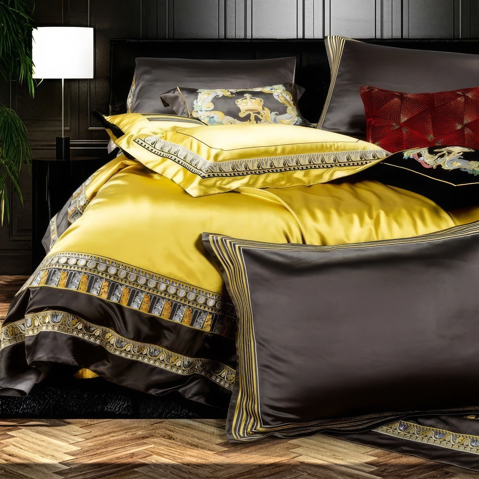 A side view of a luxurious bedding set featuring a vibrant yellow duvet bordered with intricate black and gold embroidery. Matching pillowcases in yellow and black complement the set, showcasing detailed patterns and fine stitching. A bold decorative pillow with regal embroidery adds a statement piece to the ensemble. The glossy fabric reflects a rich sheen, highlighting its premium quality, while the dark brown pillowcase with gold striped detailing enhances the sophisticated aesthetic. 