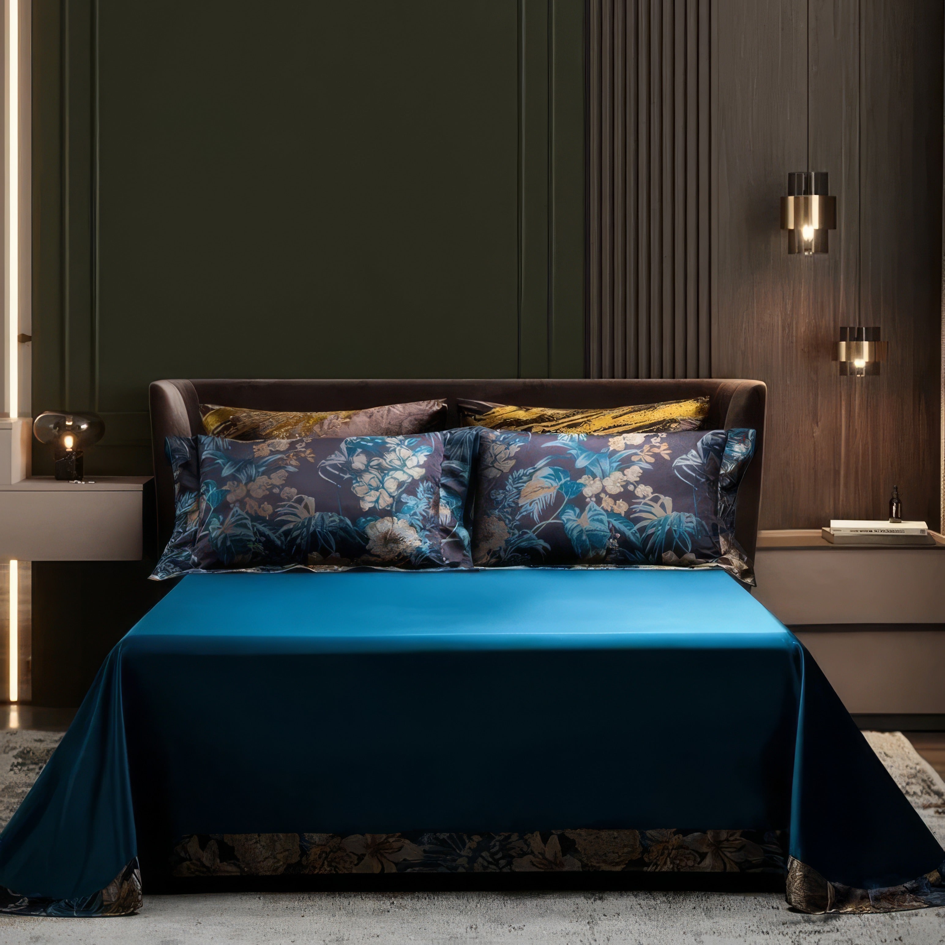 This image captures a minimalist and luxurious bedroom setting. The bedding features a rich teal bedspread paired with dark floral-patterned pillowcases in deep navy and teal tones. The sleek and modern room design, complemented by subtle ambient lighting and a clean backdrop, enhances the elegance of the bedding set. This setup conveys sophistication and refined taste, ideal for a premium bedroom aesthetic.