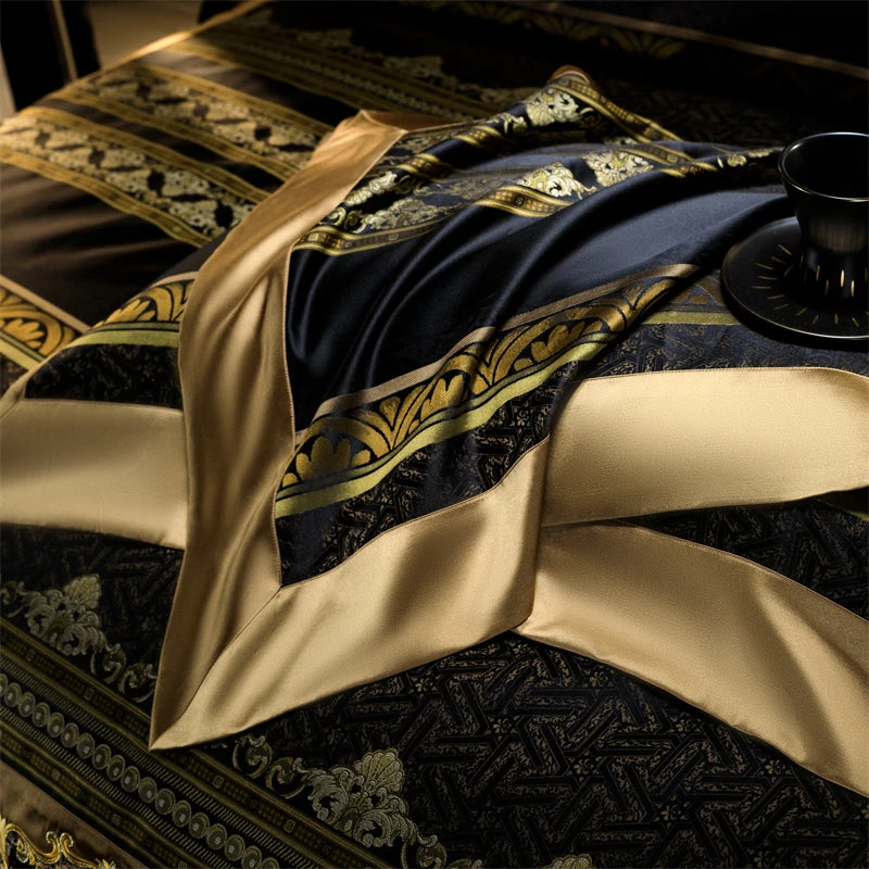 This image highlights a close-up view of a luxurious bedding set's intricate detailing. The fabric showcases a blend of rich black and gold satin, with an ornate embroidered medallion motif adding a regal touch. The smooth and shiny satin texture enhances the opulence, while the corner embroidery reflects fine craftsmanship. The elegant color contrast and detailed embellishment make this bedding piece an ideal choice for an upscale, sophisticated bedroom décor.