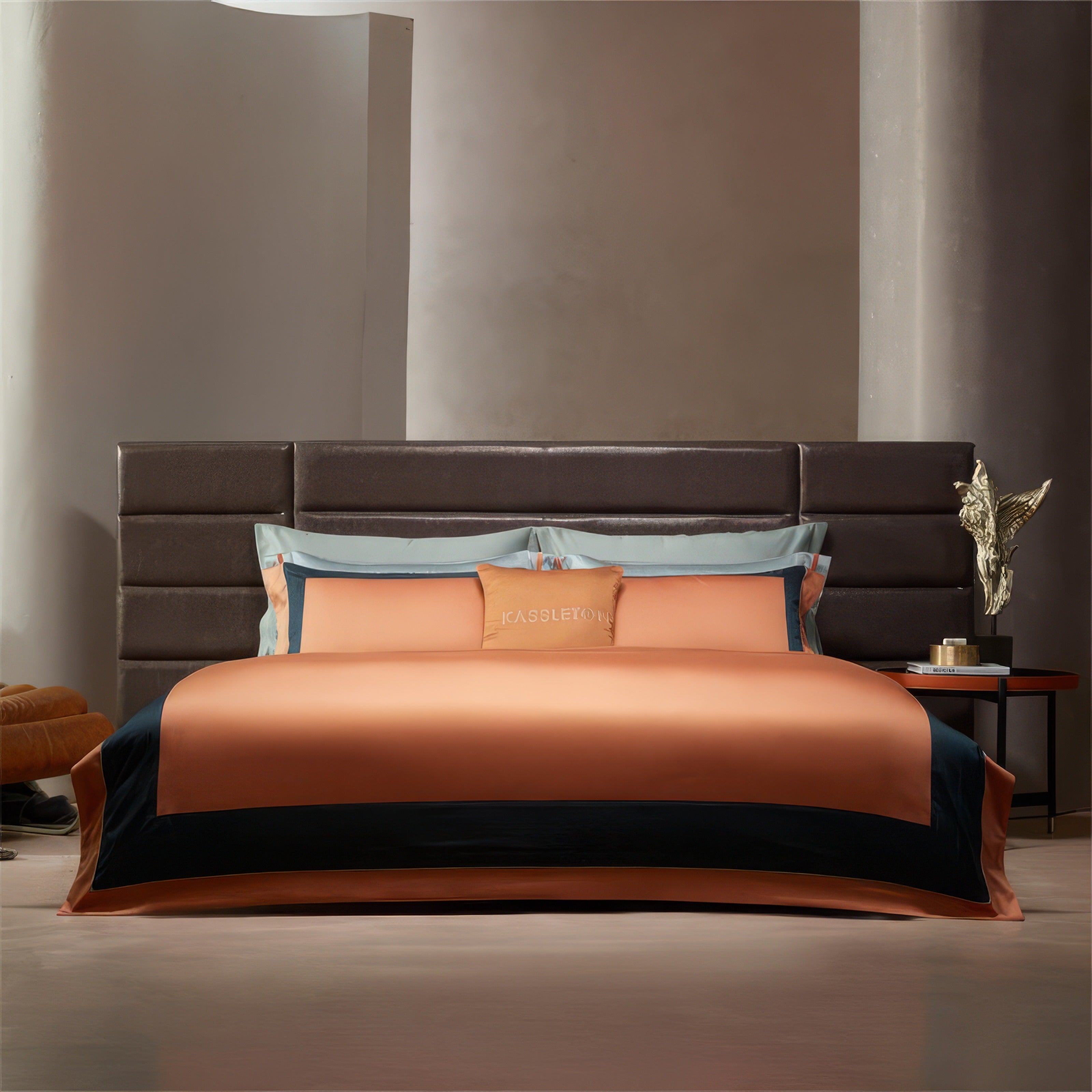 Elegant orange bedding with contrasting black accents along the border, paired with matching pillow shams. The smooth fabric exudes a subtle sheen, creating a contemporary, luxurious aesthetic against a soft neutral-toned background. The decorative pillow adds a refined touch with embroidered branding.

