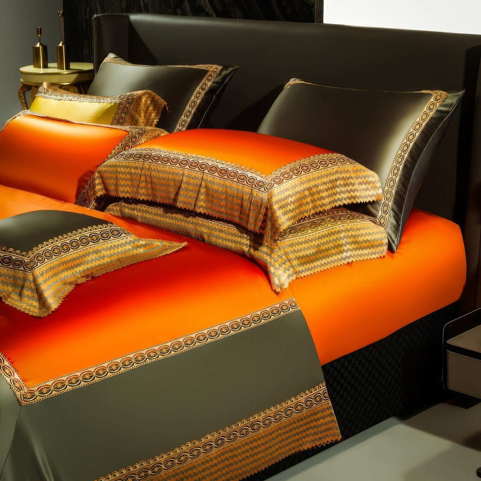 Vibrant orange bedding set with intricate gold and olive green embroidered details on pillowcases and duvet cover. The luxurious design features contrasting textures and bold colors for an elegant look.

