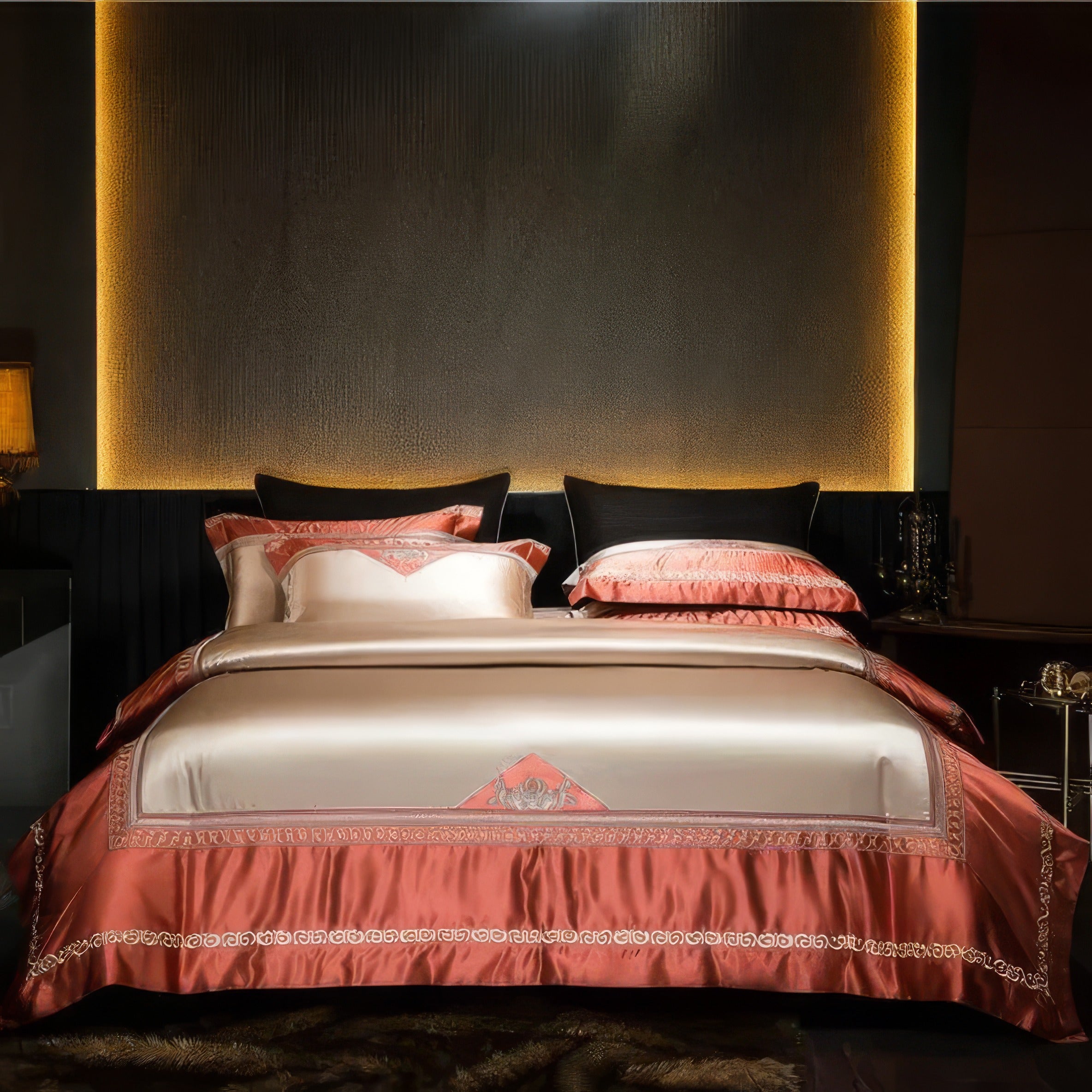 A stunning bedroom setup featuring luxurious bedding in champagne and coral tones. The satin finish adds a luminous glow, while intricate gold embroidery embellishes the edges, enhancing the opulent design. A sophisticated ambiance is created with the warm lighting, sleek black headboard, and golden accents in the decor.

