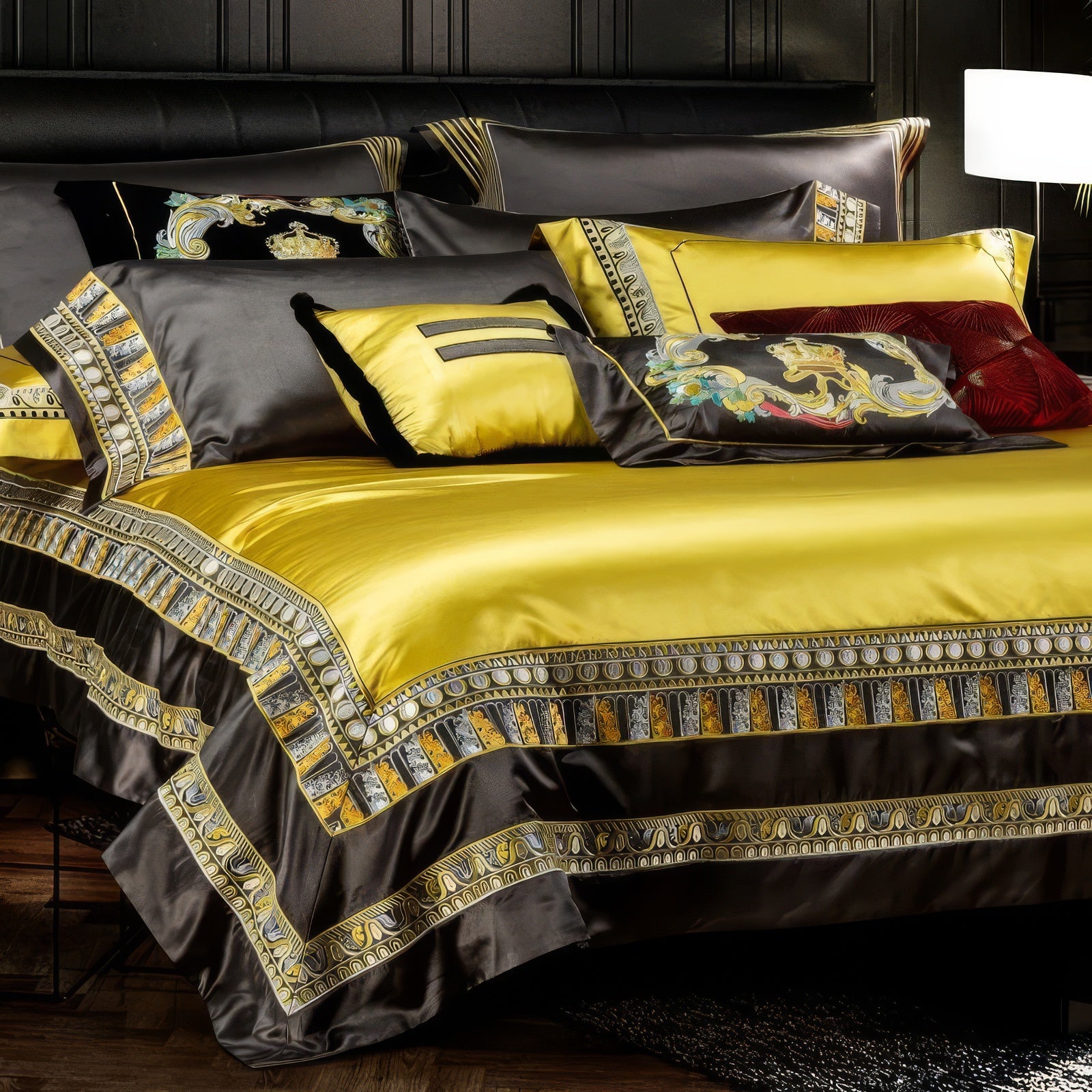 A close-up view of an elegant bedding set featuring a bold yellow duvet bordered with intricate black and gold patterns, paired with matching pillowcases. The design showcases luxurious embroidery and fine detailing, accentuated by decorative pillows, including one with regal motifs and another in rich red velvet. The contrast between the vibrant yellow and dark black fabrics adds depth and opulence, perfectly complementing a high-end, sophisticated bedroom ambiance.

