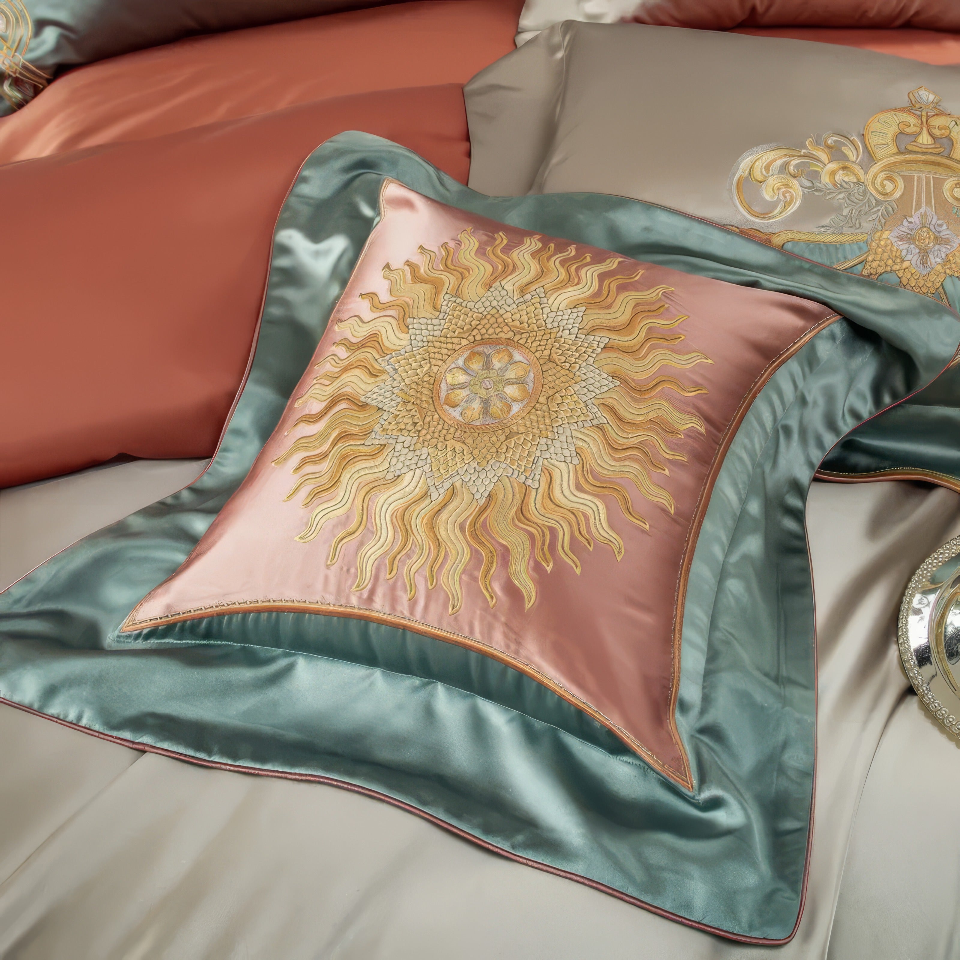 A detailed close-up of a decorative square pillowcase featuring a radiant sun motif in golden embroidery, meticulously crafted on a luxurious coral satin fabric. The intricate embroidery is framed by a soft teal border, creating a harmonious color contrast that exudes elegance and sophistication. The silky sheen of the fabric enhances the opulent texture, while the surrounding bedding in complementary hues adds to the luxurious ambiance of the set.