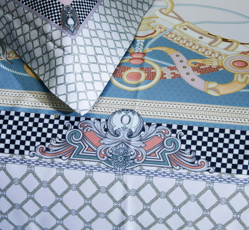 Close-up of a bedding set featuring intricate patterns, including a light gray lattice design, a bold checkerboard border, and detailed equestrian-inspired elements in pastel blue, pink, and gold. The pillowcase matches the duvet cover with a consistent grid and decorative accents.

